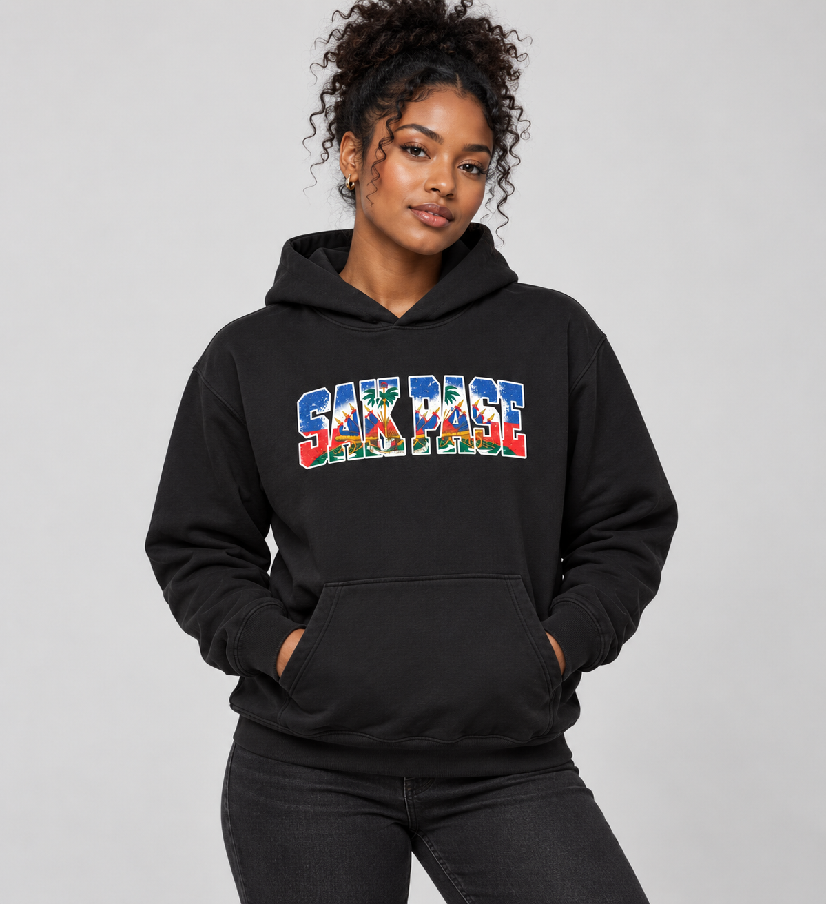 Female model wearing black SAK PASE hoodie with smaller chest print and hood without drawstrings